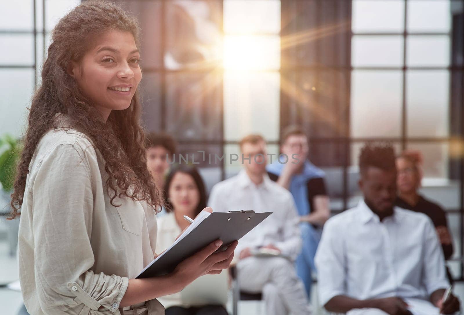 Mid adult businesswoman explaining business strategy to colleagues in training class