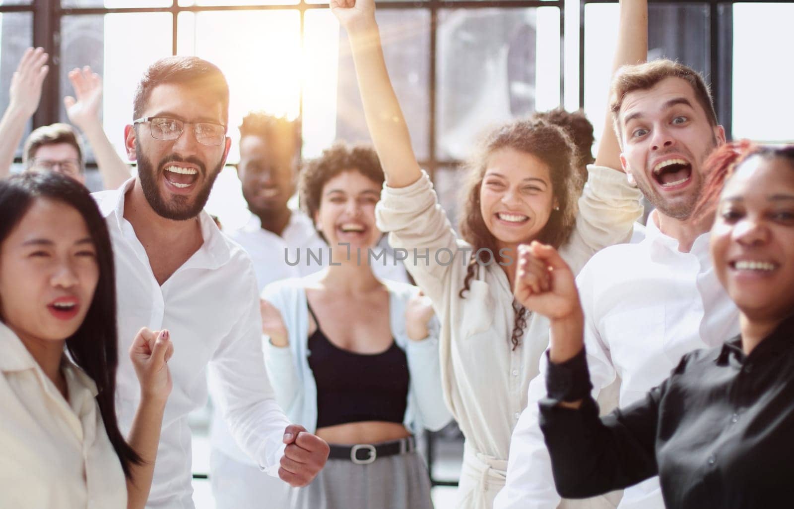 Raised up hands and arms of large group in seminar class room to agree with speaker at conference seminar meeting room