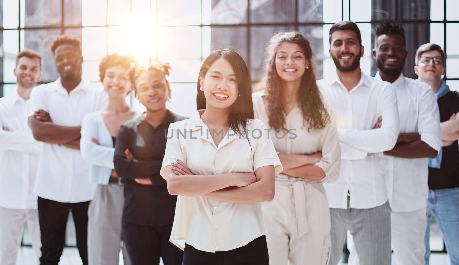 Happy diverse professional business team stand in office looking at camera