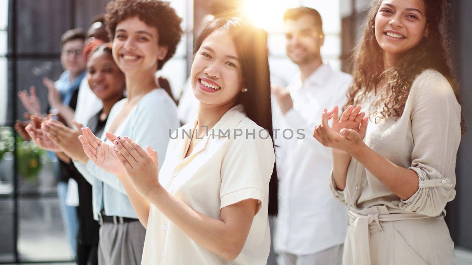 arge international group of happy people applauding together