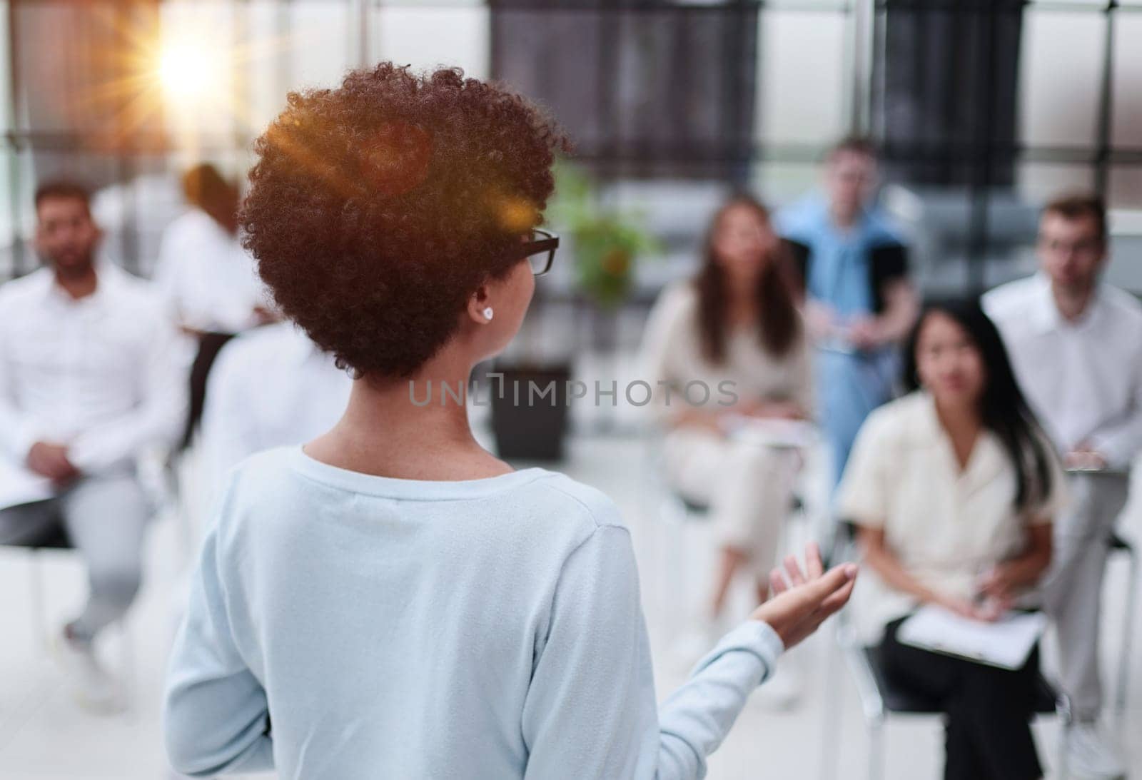 Selective focus of young businesswoman together with interracial colleagues during seminar