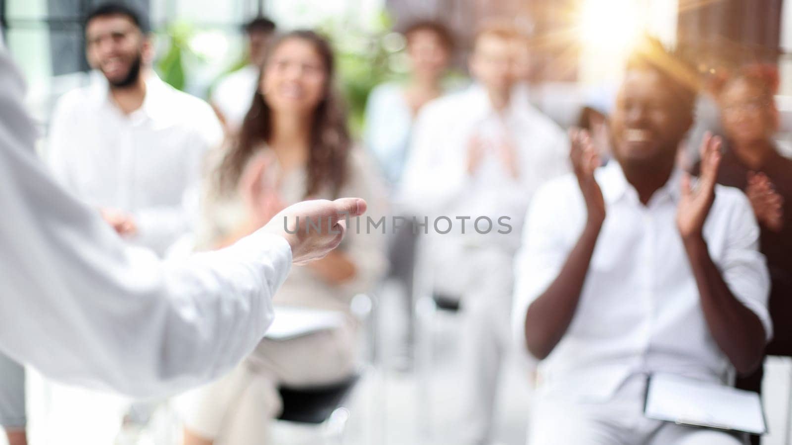 Selective focus of young businesswoman together with interracial colleagues during seminar