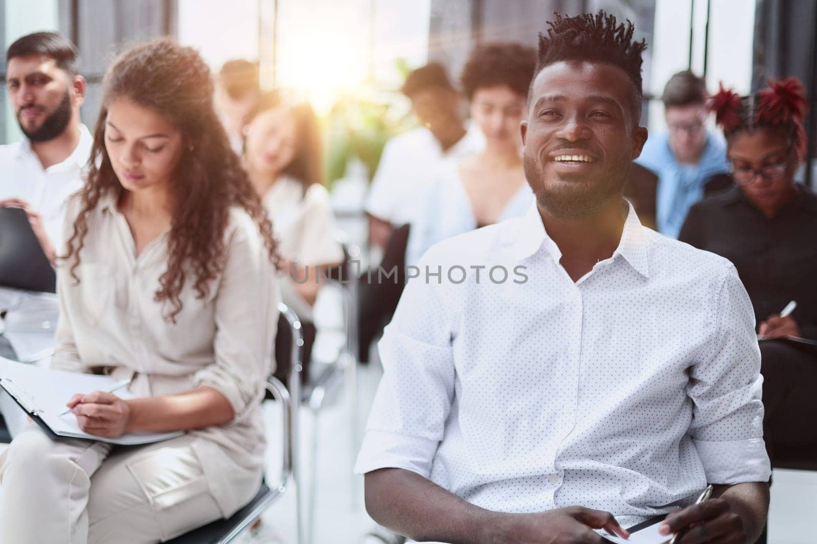 Audience at the conference hall. Business and Entrepreneurship concept. Focus on unrecognizable people in audience.