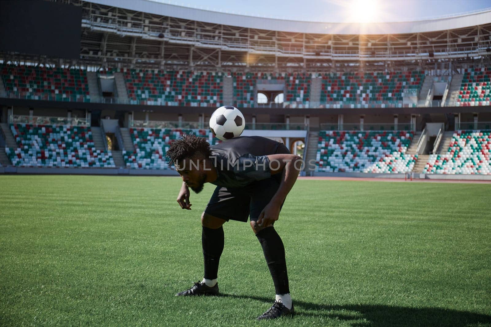 one football player is training holding the ball with his back. African American football player in training.