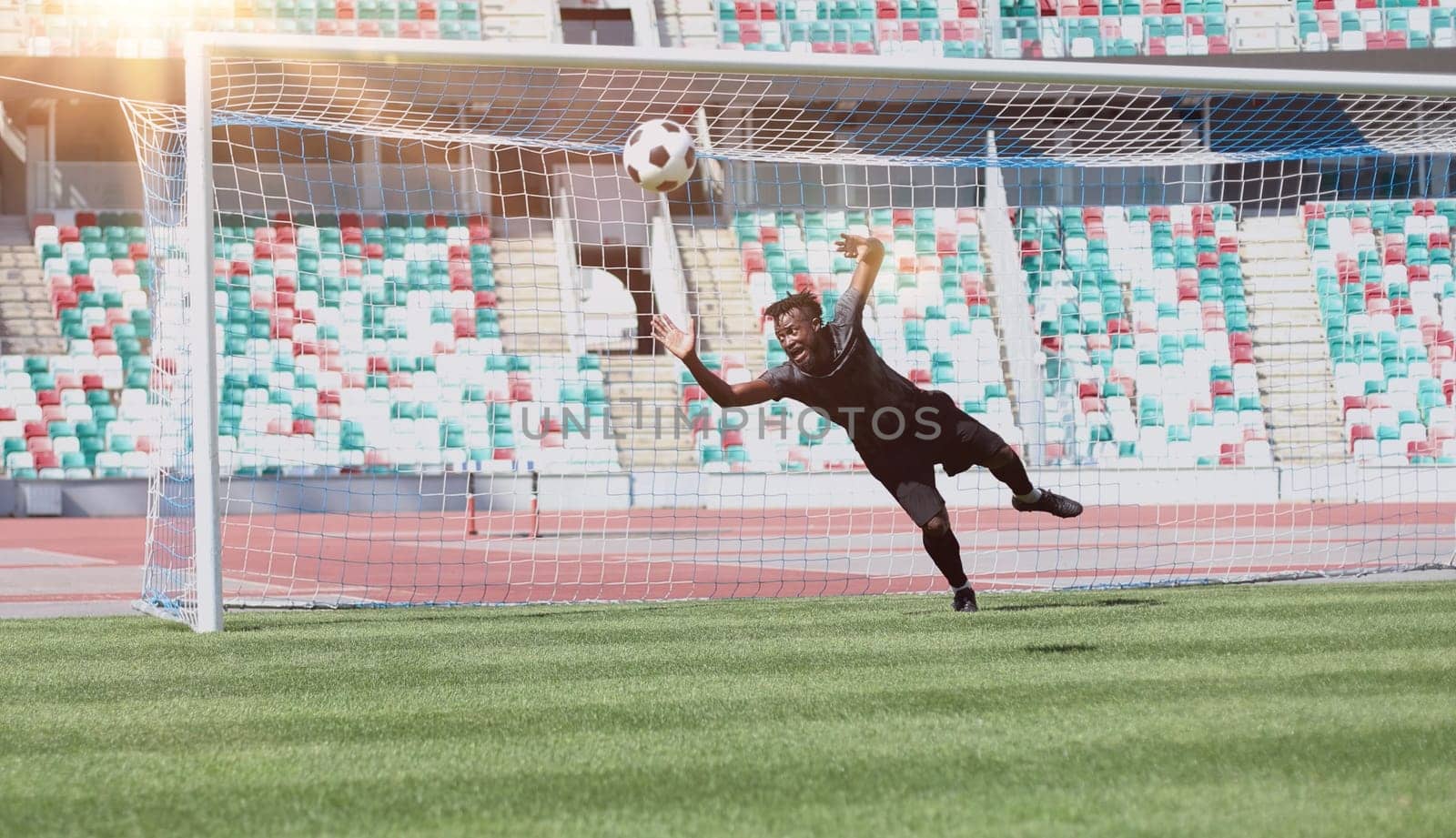 Football goalkeeper catches the ball in the stadium. game concept