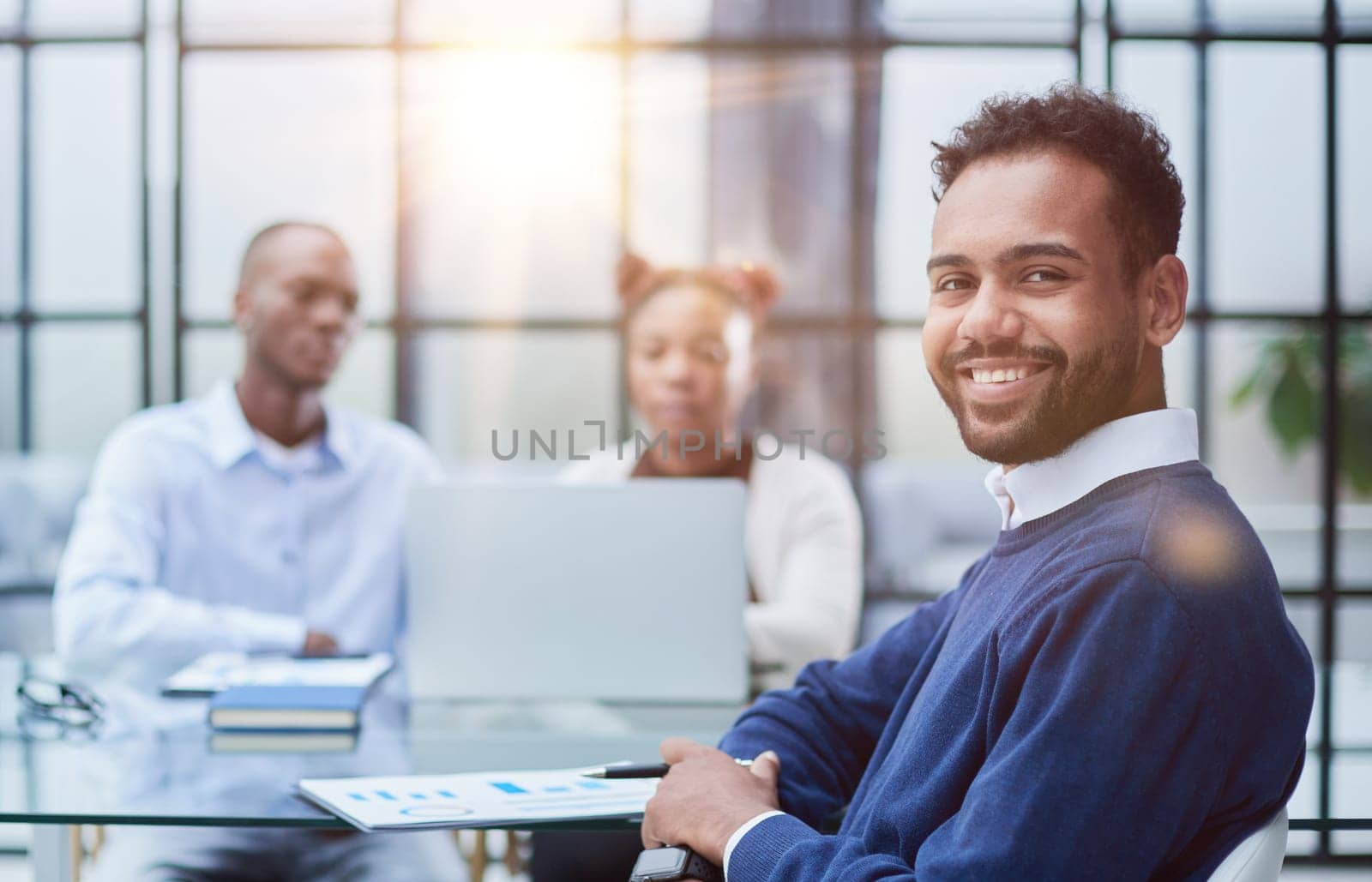 Portrait of African American businessman sitting at desk in an office