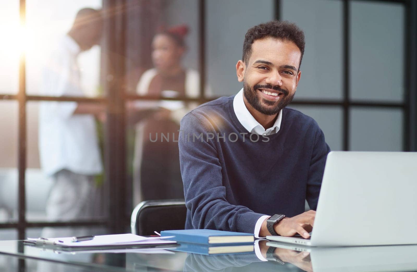 African businessman working on a laptop in an office by Prosto