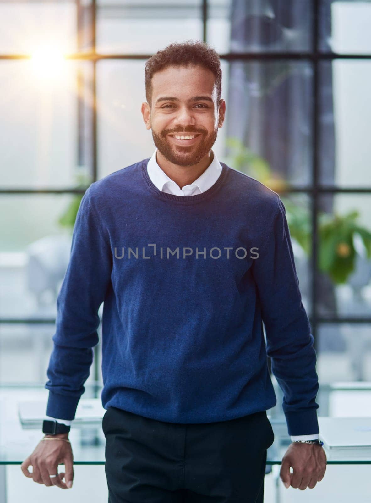 Cheerful young African man in full suit keeping arms crossed and looking at camera by Prosto