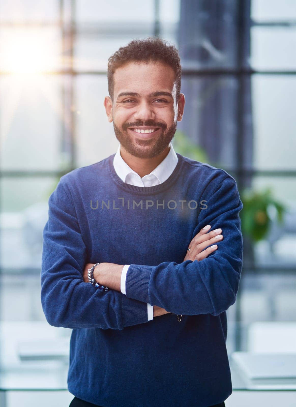 Cheerful young African man in full suit keeping arms crossed and looking at camera by Prosto