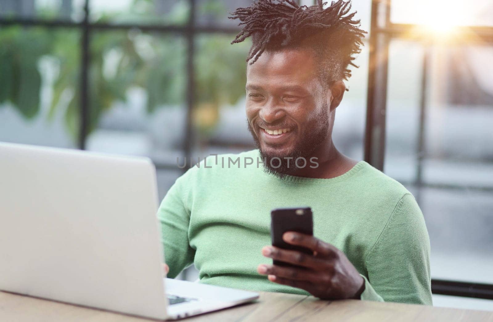 Black businessman talking on cell phone at office