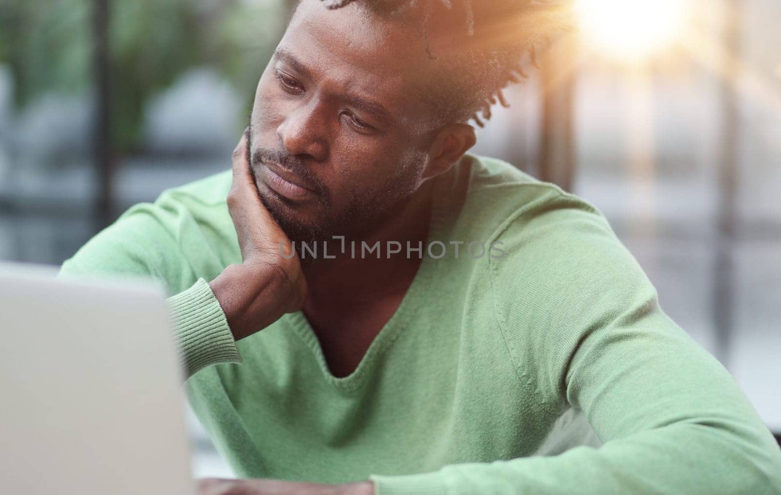 Young businessman holding his head and pondering