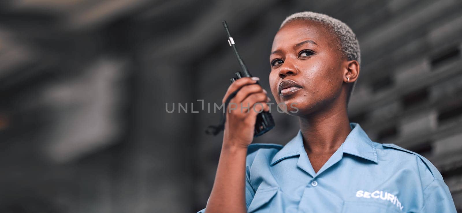 Security, radio and a black woman police officer in the city during her patrol for safety or law enforcement. Walkie talkie, communication and service with a female guard on a street in an urban town.
