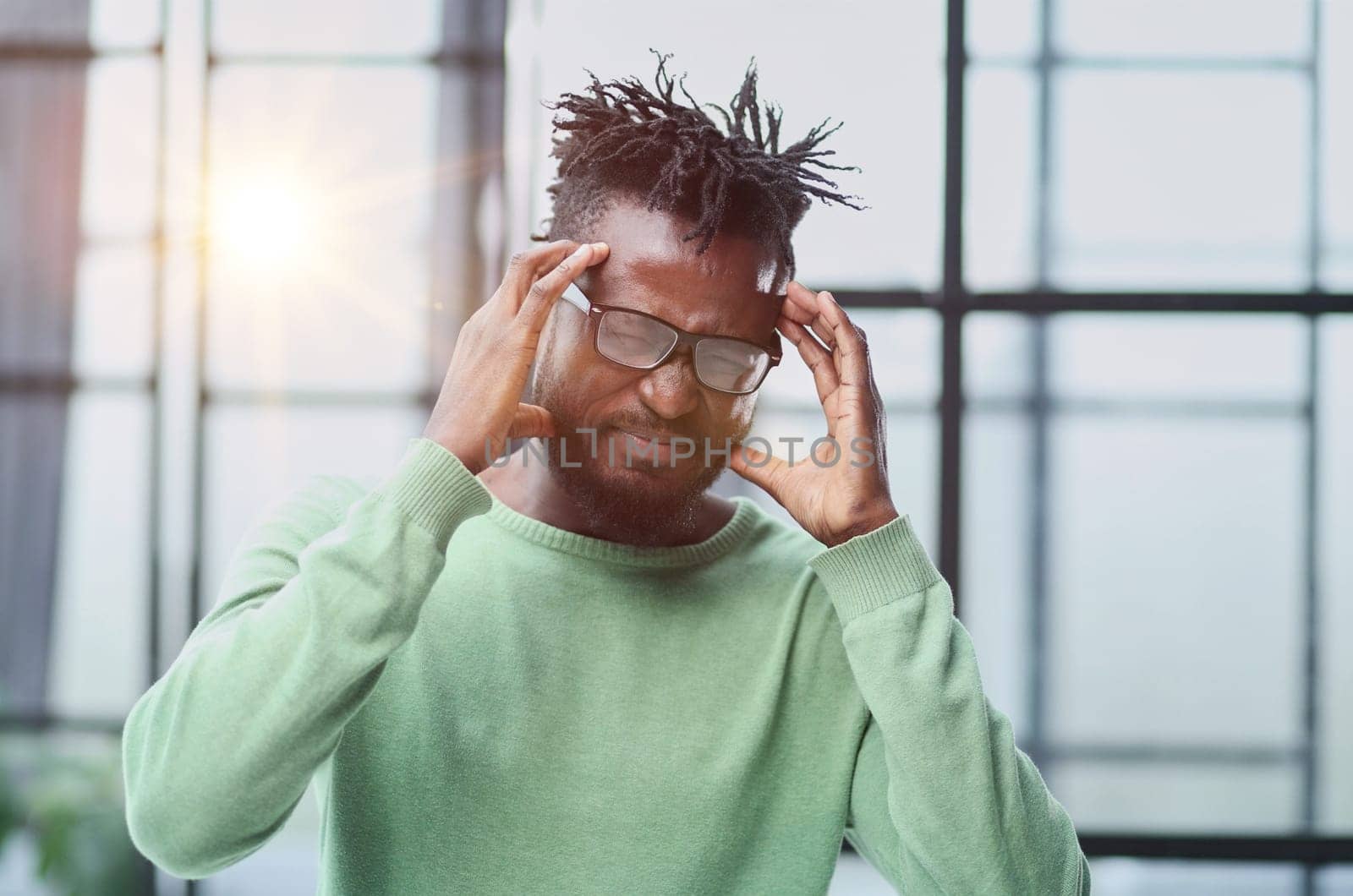 Portrait of sad unhappy African man having bad headache