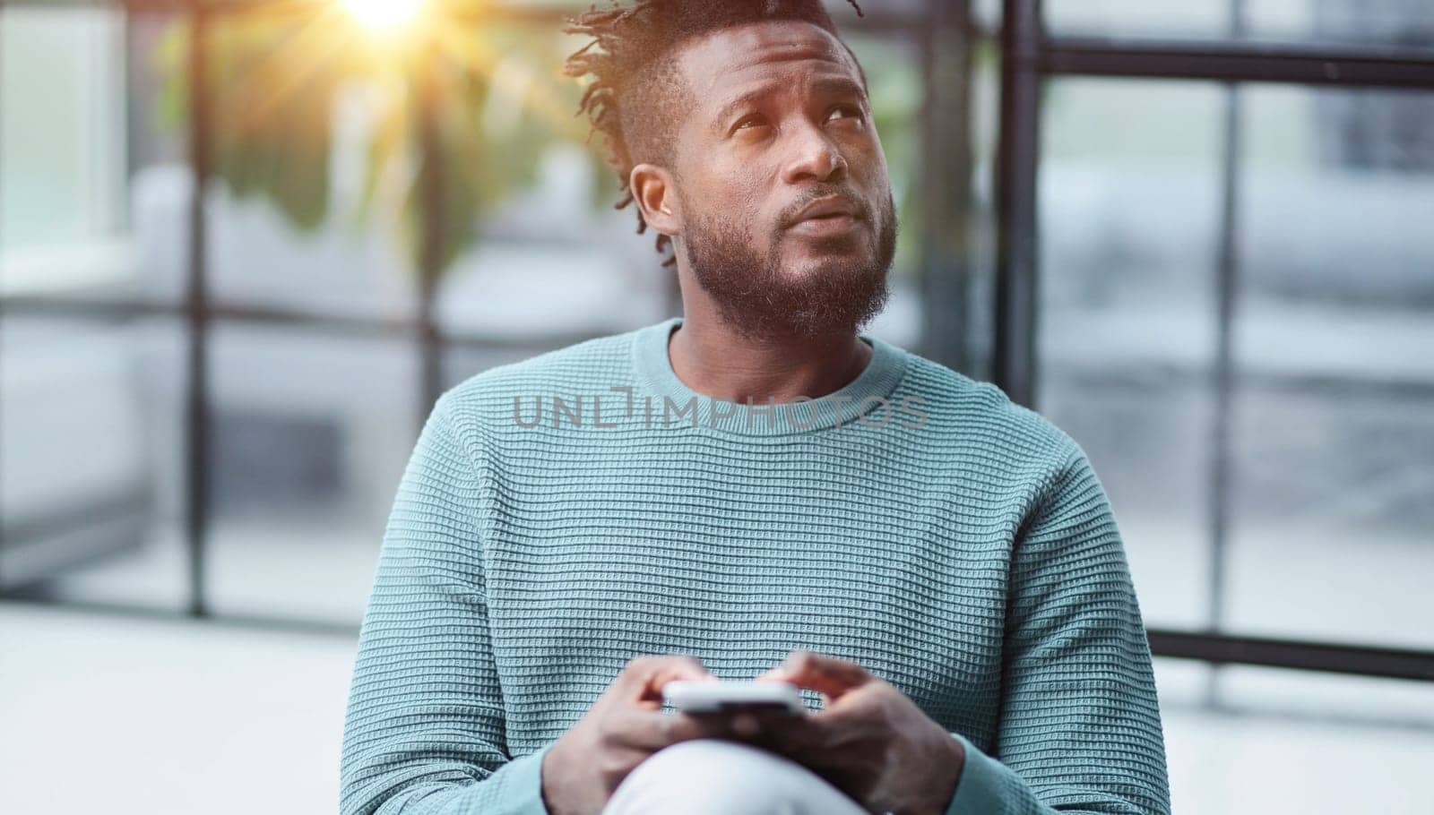 african american businessman using phone mobile corporate apps at workplace texting sms.