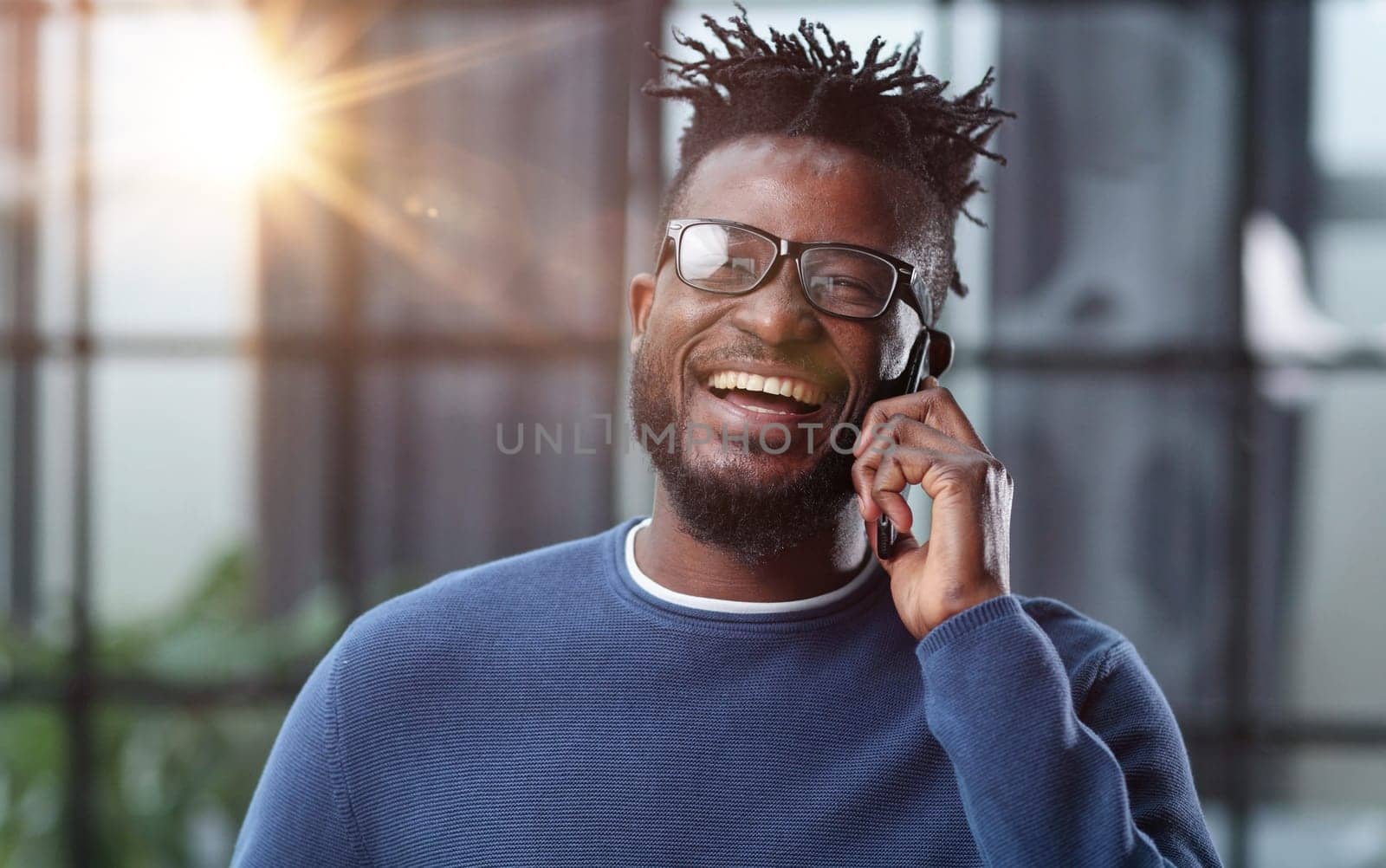 communication and technology concep african american businessman calling on smartphone at office