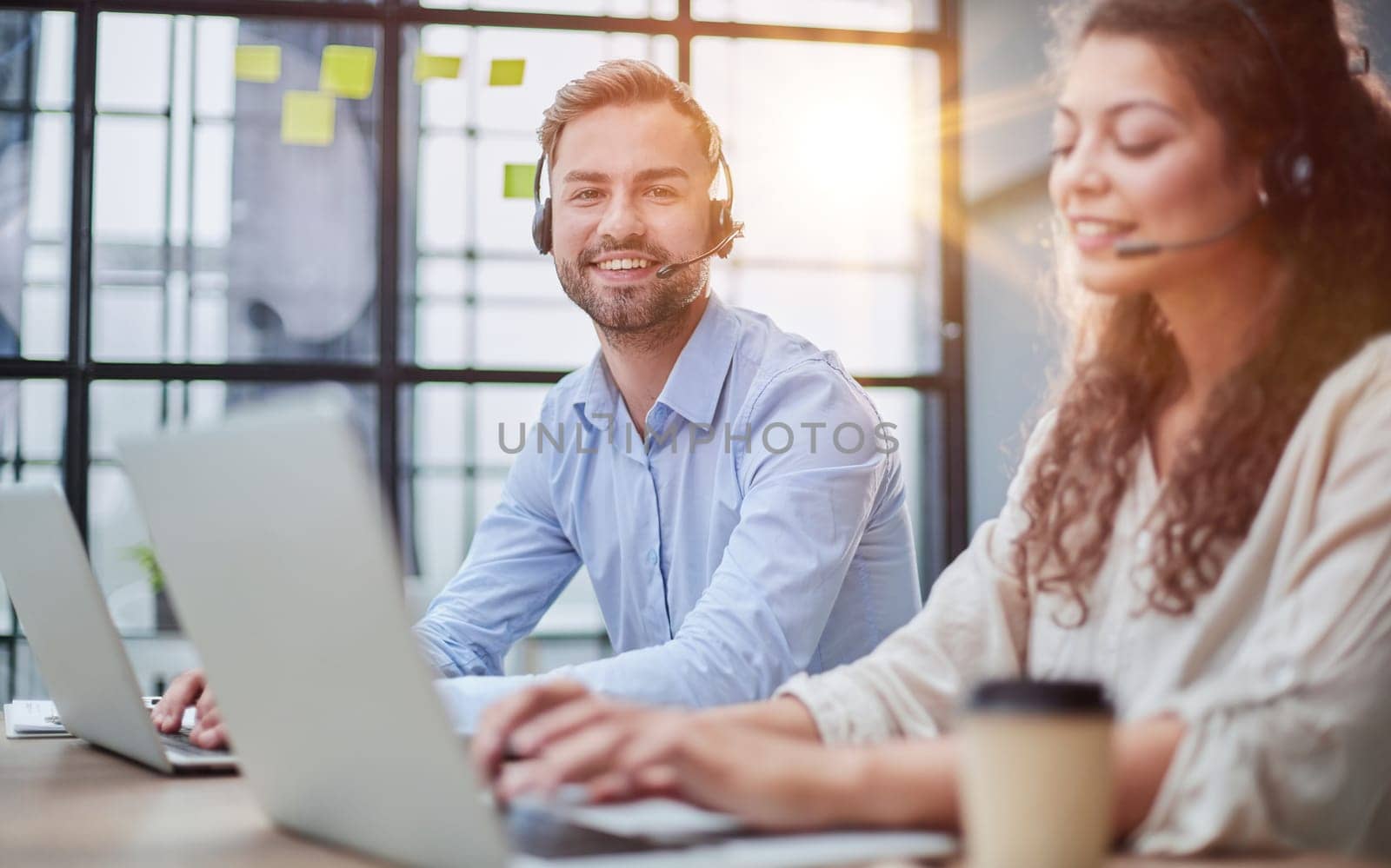 Customer Service Representative With Colleague Working In Office