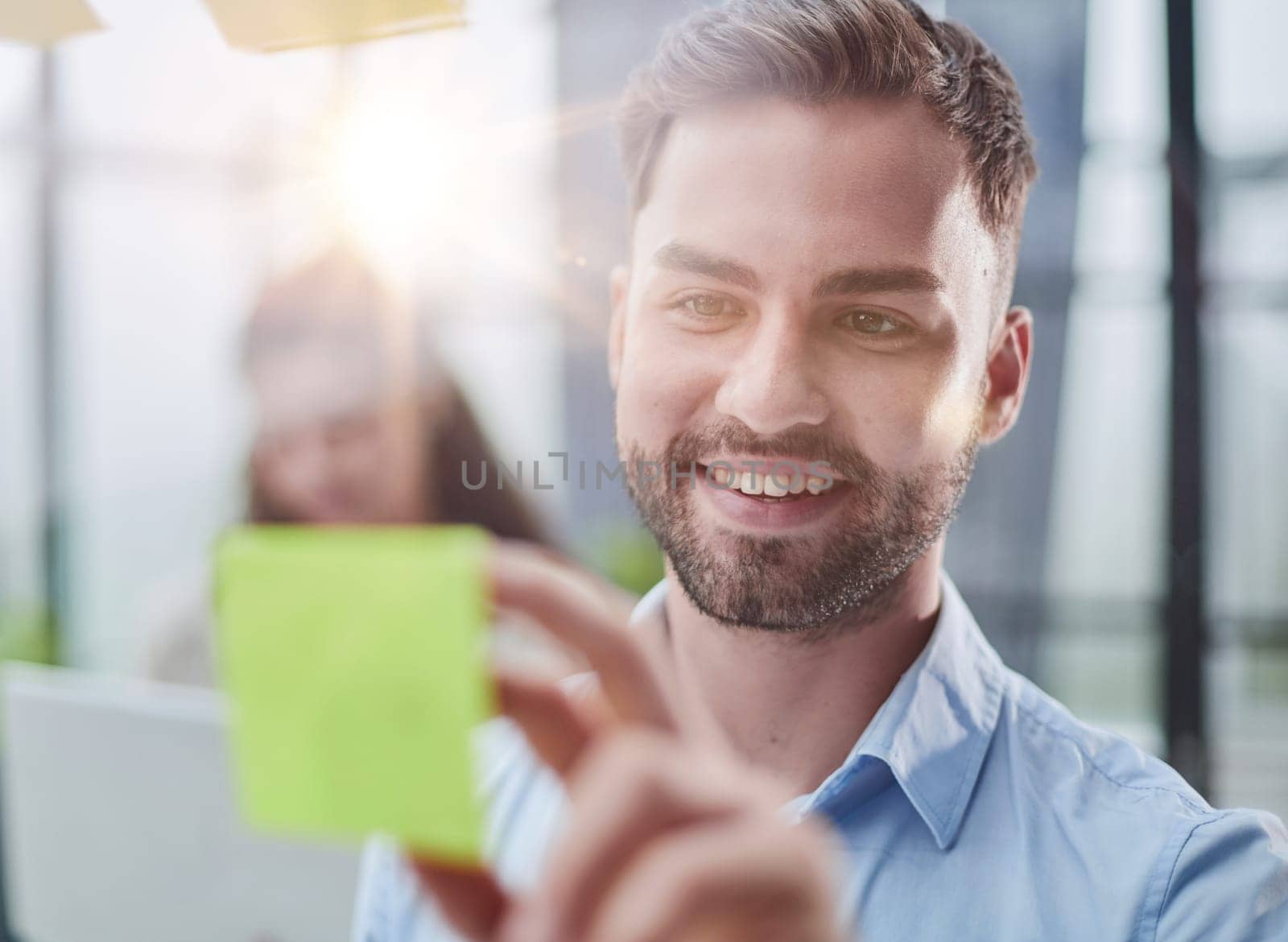 businessman is working on a project. Business man pointing at a note on the glass wall