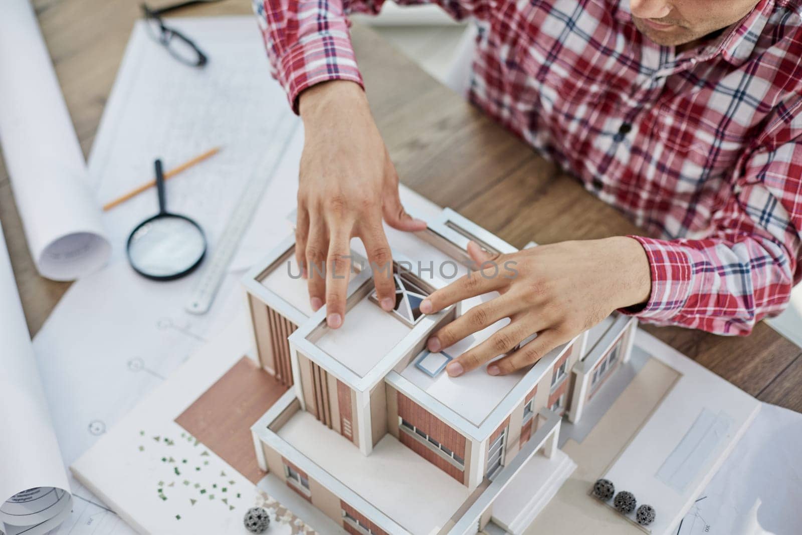Close up view og real estate agent with house model. home loan and insurance concept.