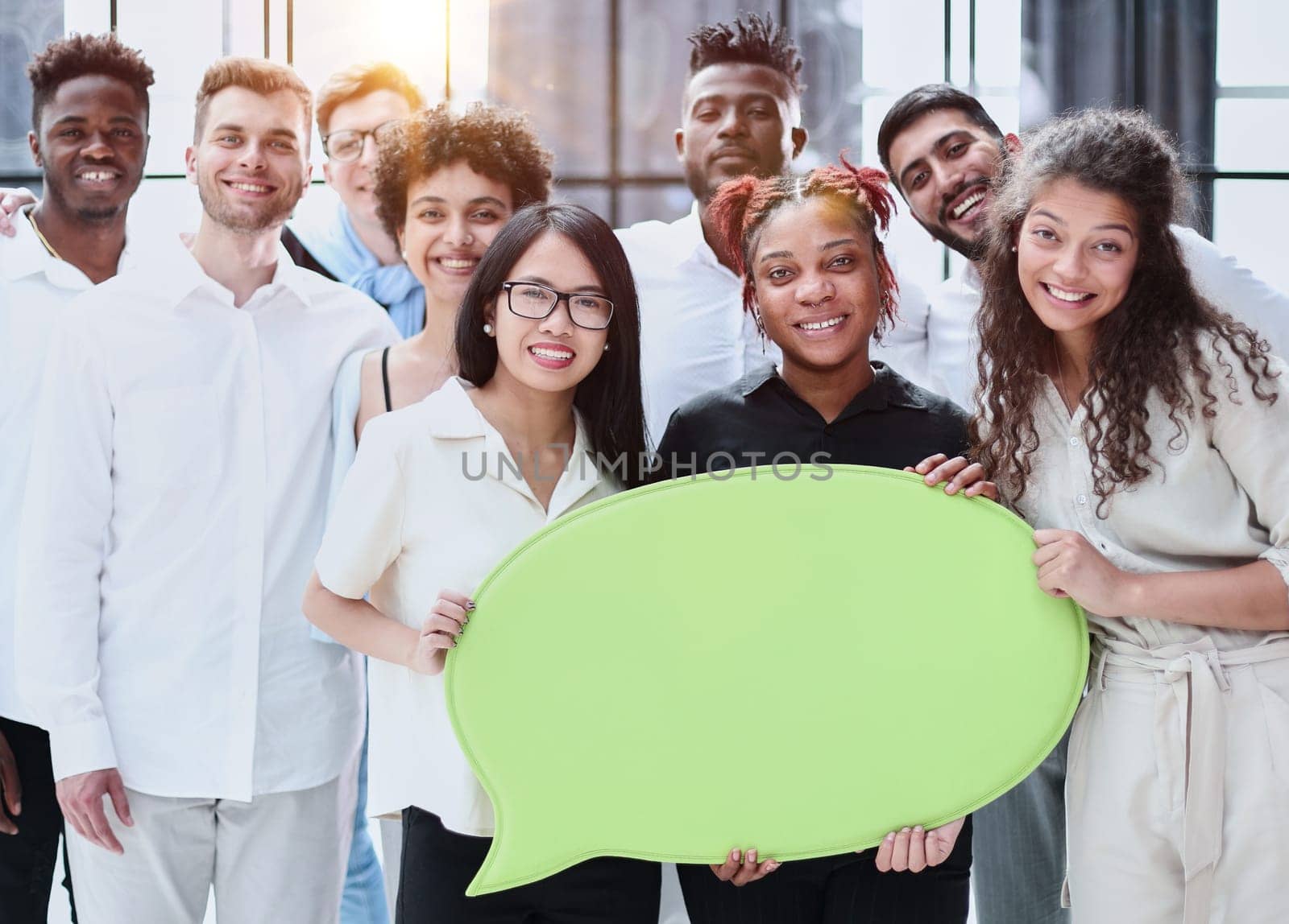 Business team consisting of young business people standing with a comment