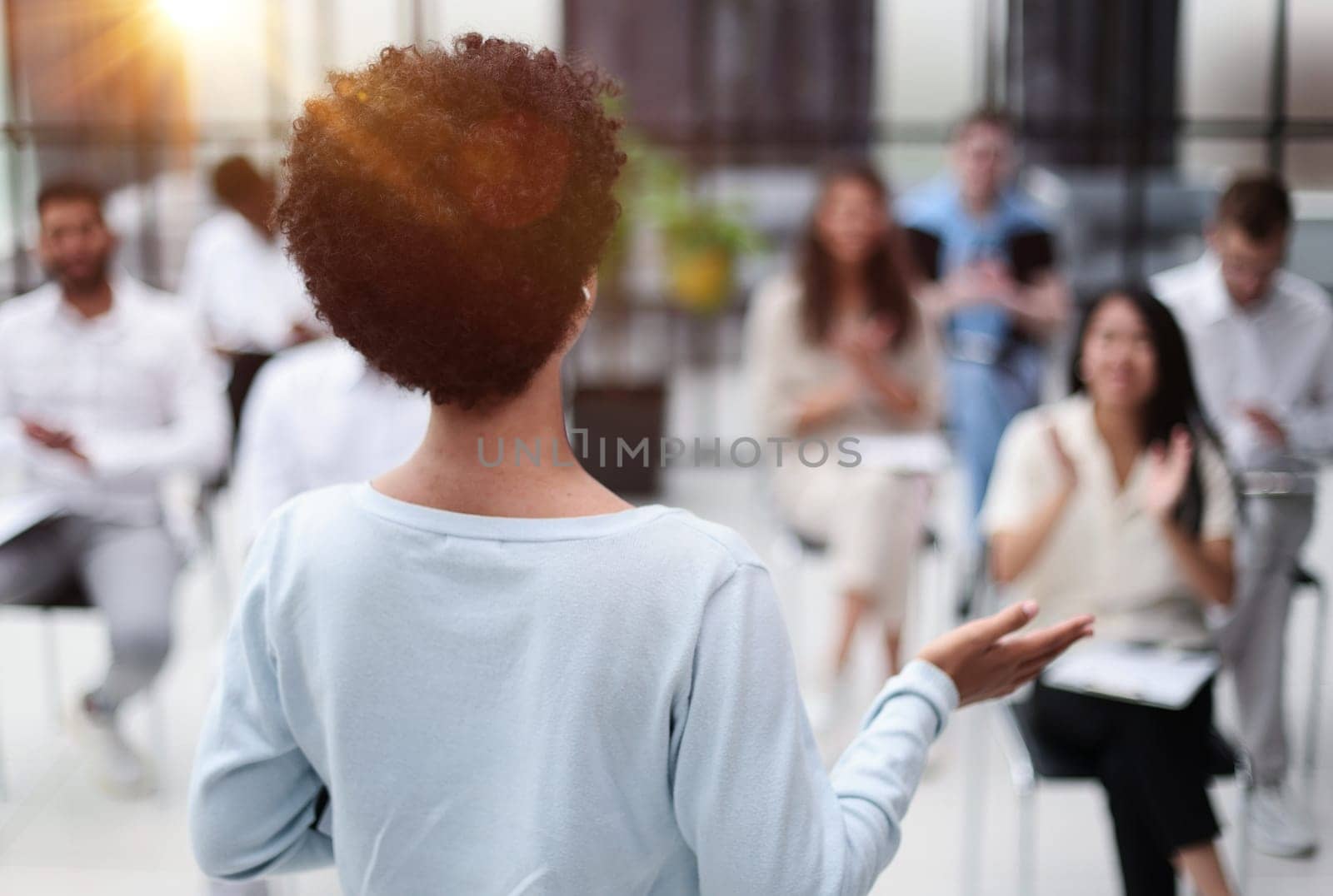 Selective focus of young businesswoman together with interracial colleagues during seminar