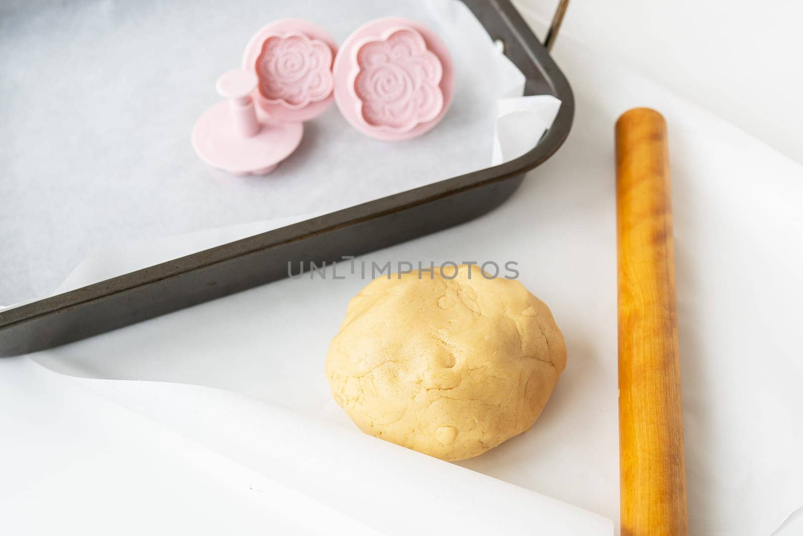 Preparation of dough for making cookies with molds in the form of flowers, a rolling pin and a baking sheet, Concept of cooking food baking at home