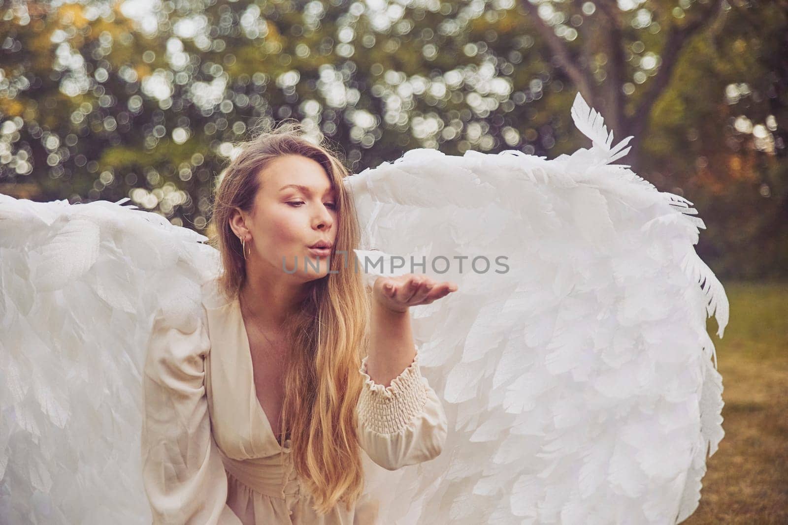 Olstrup, Denmark, June 6, 2023: Beautiful girl dressed as an angel in the garden
