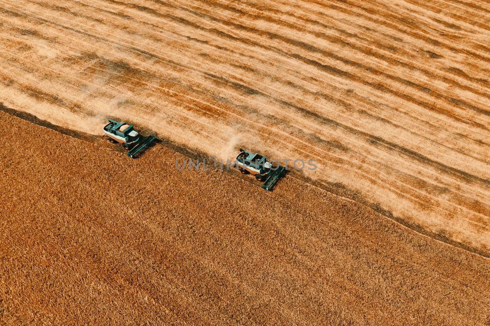 aerial view of two combine on harvest field by fascinadora