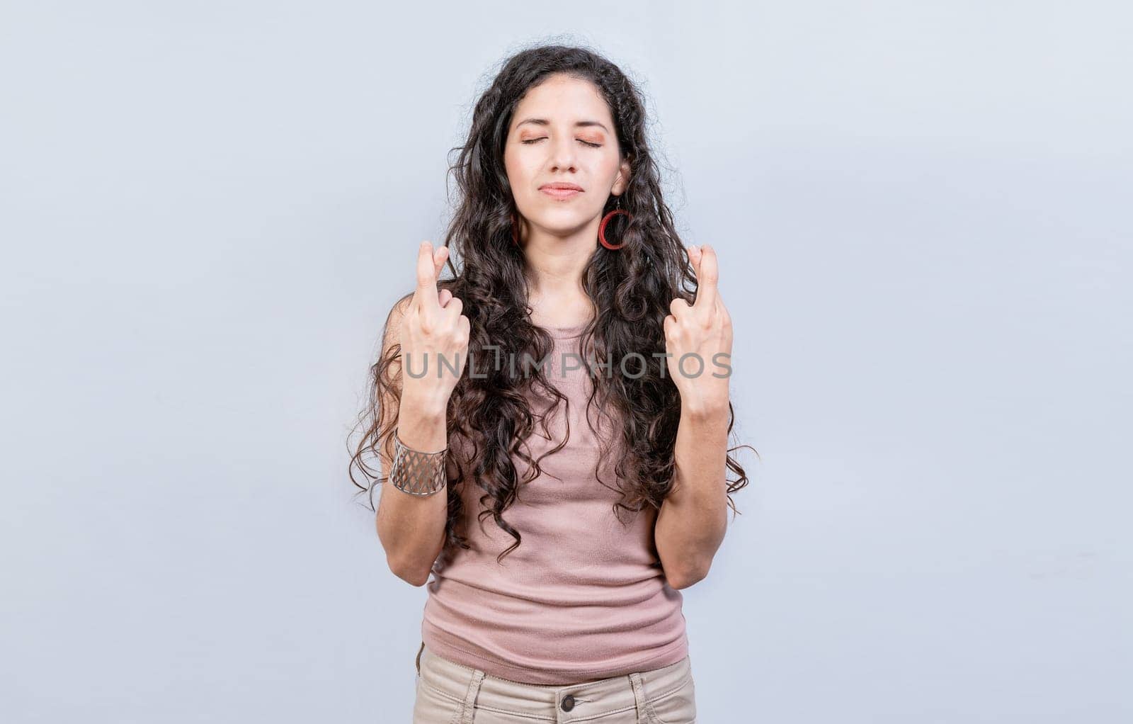 Hopeful woman making a wish isolated, Superstitious people making a wish. Worried girl crossing her fingers making a wish