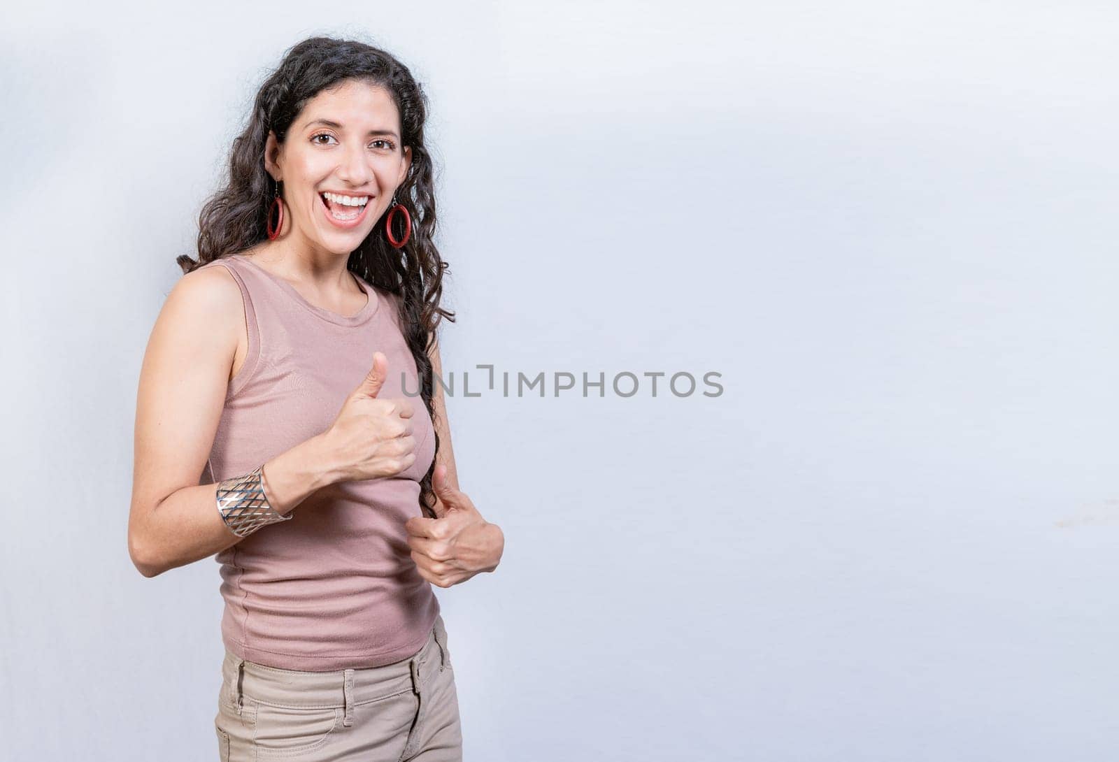 Happy smiling woman with thumbs up doing ok. Happy girl with thumbs up on isolated background, Smiling woman showing ok gesture isolated by isaiphoto