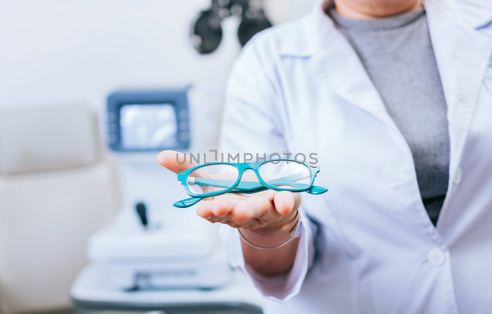 Optometrist hands showing a glasses. Oculist giving glasses in palm hand. Eyeglasses and visual health concept