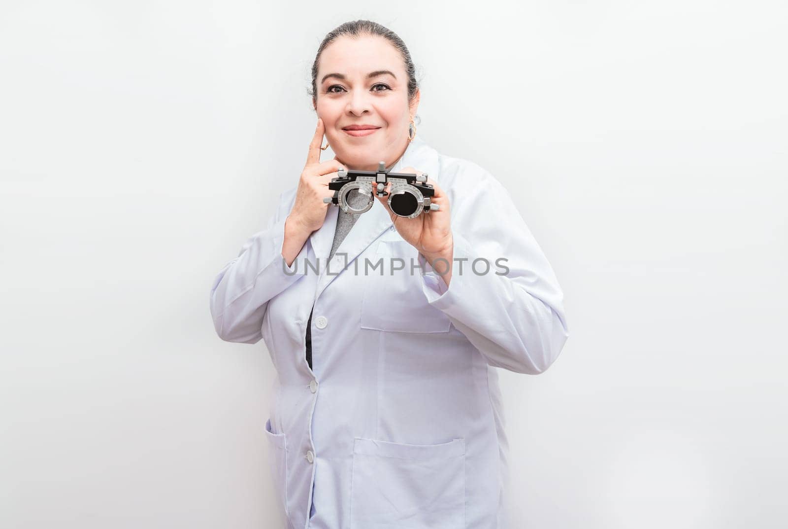 Smiling ophthalmologist holding a messbrille isolated. Portrait of optometrist holding a messbrille lens isolated by isaiphoto