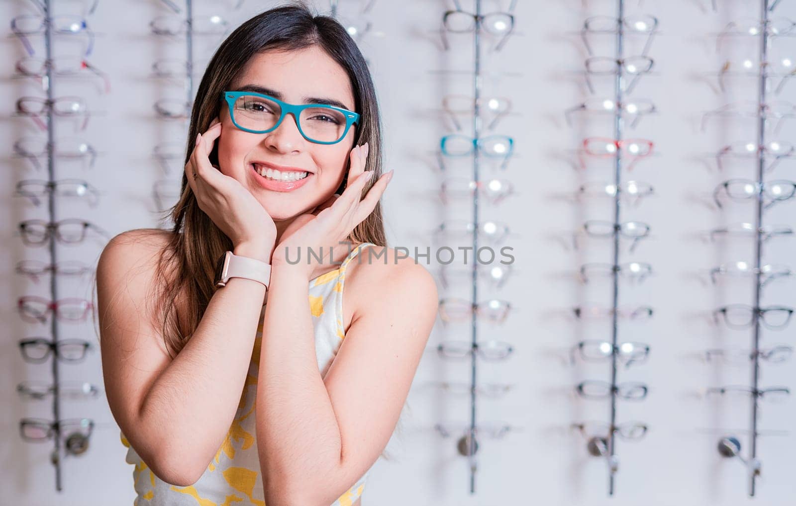 Smiling happy girl in eyeglasses with store eyeglasses background, Portrait of happy girl in glasses in an eyeglasses store
