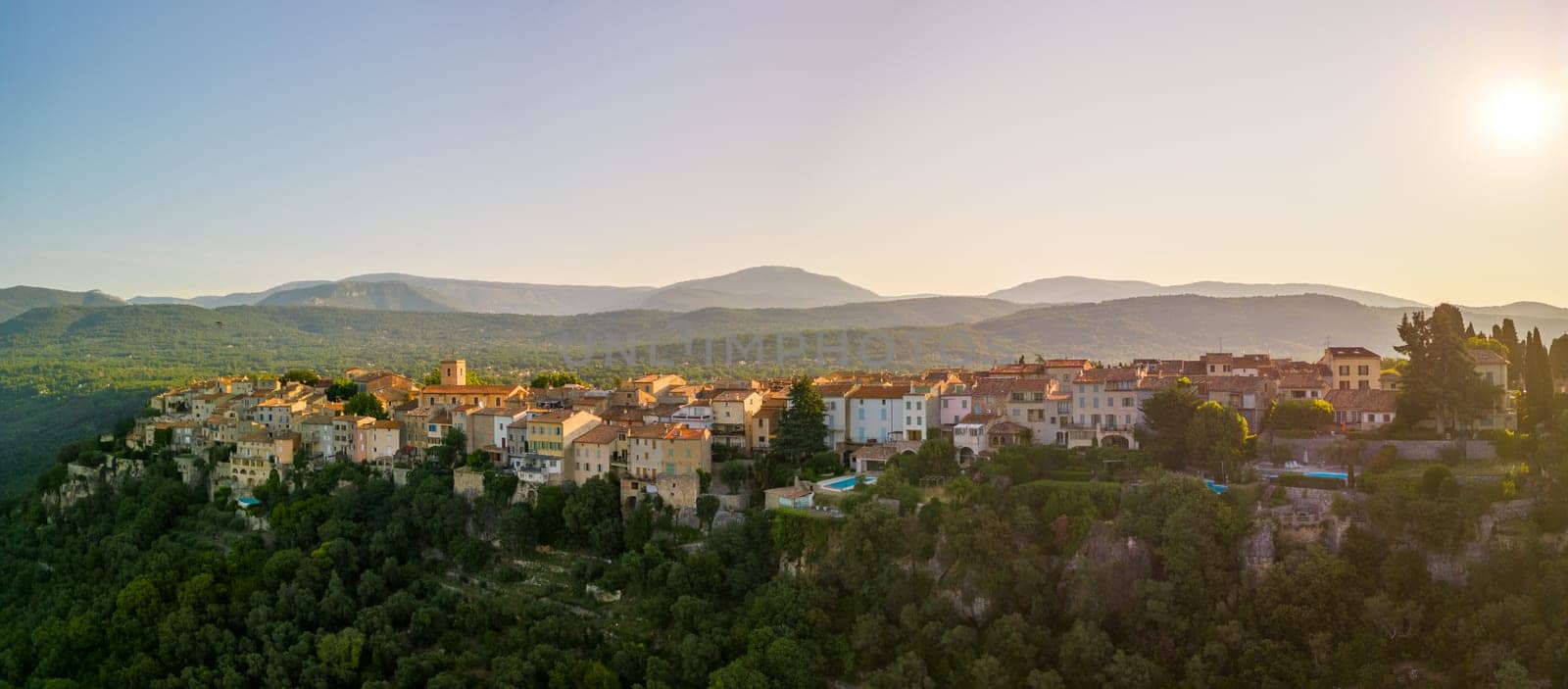 Early morning sun hits historic buildings in French mountain village. High quality photo