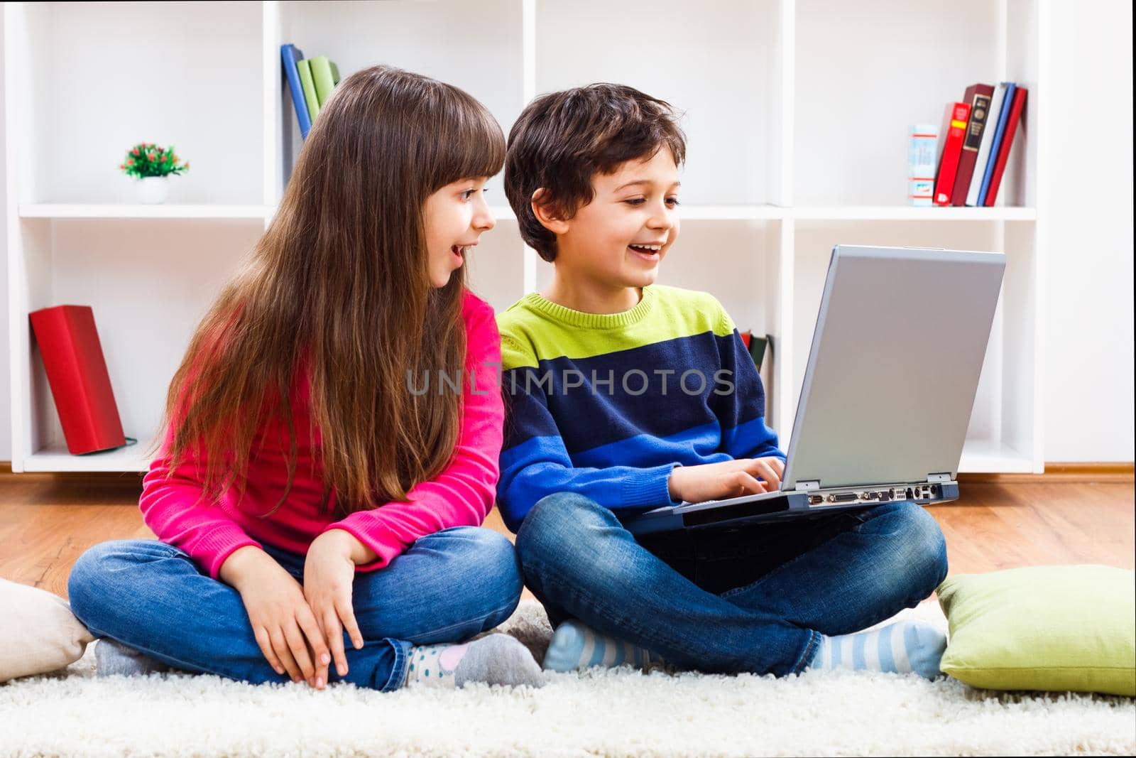 Image of children using laptop at home.