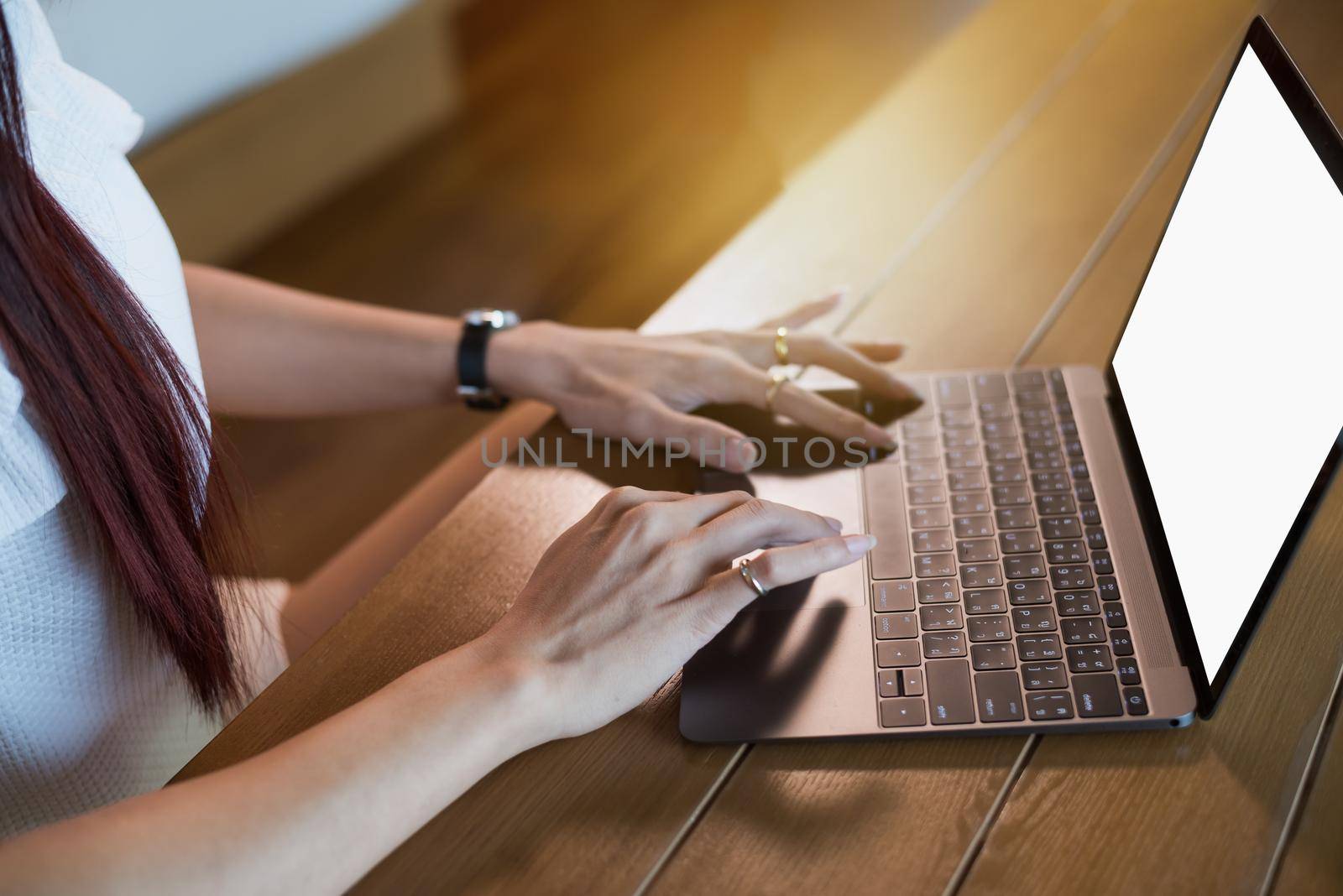 Woman working at home office hand on keyboard close up by Wmpix