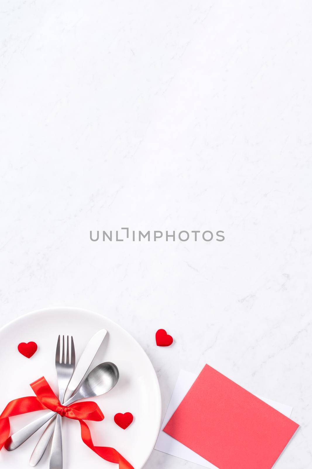 Valentine's Day, Mother's Day, holiday dating meal, banquet design concept - White plate and red ribbon on marble background, top view, flat lay. by ROMIXIMAGE