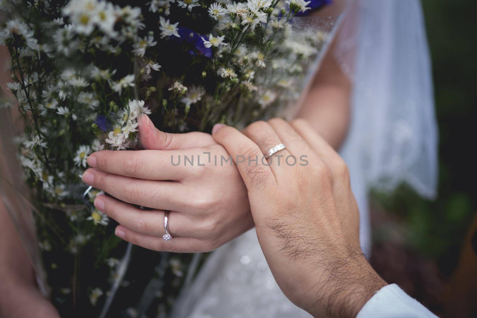 Newly-married couple holding hands