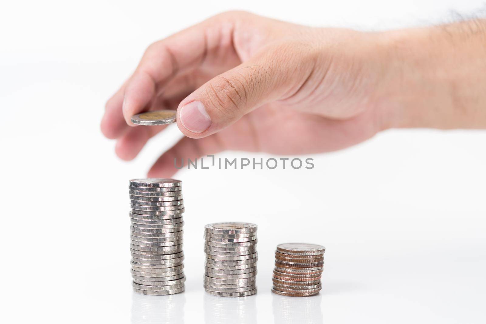 hand putting coin on white background, Saving money