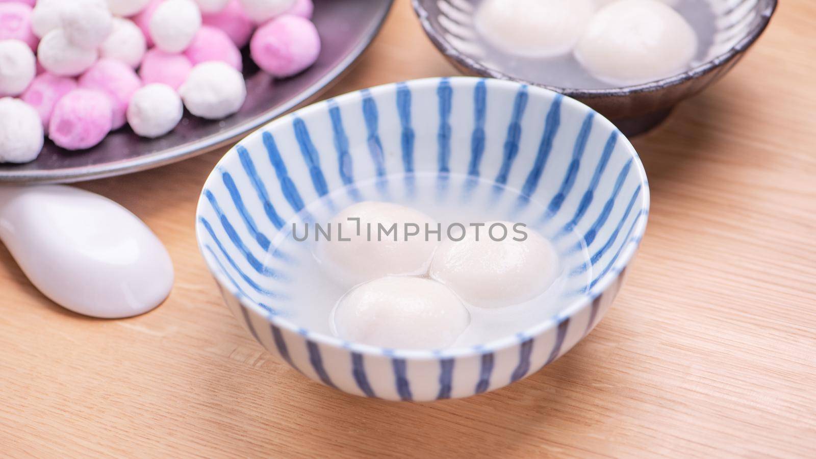 Tang yuan, tangyuan, yuanxiao in a small bowl. Delicious asian traditional festive food rice dumpling balls with stuffed fillings for Chinese Lantern Festival, close up.