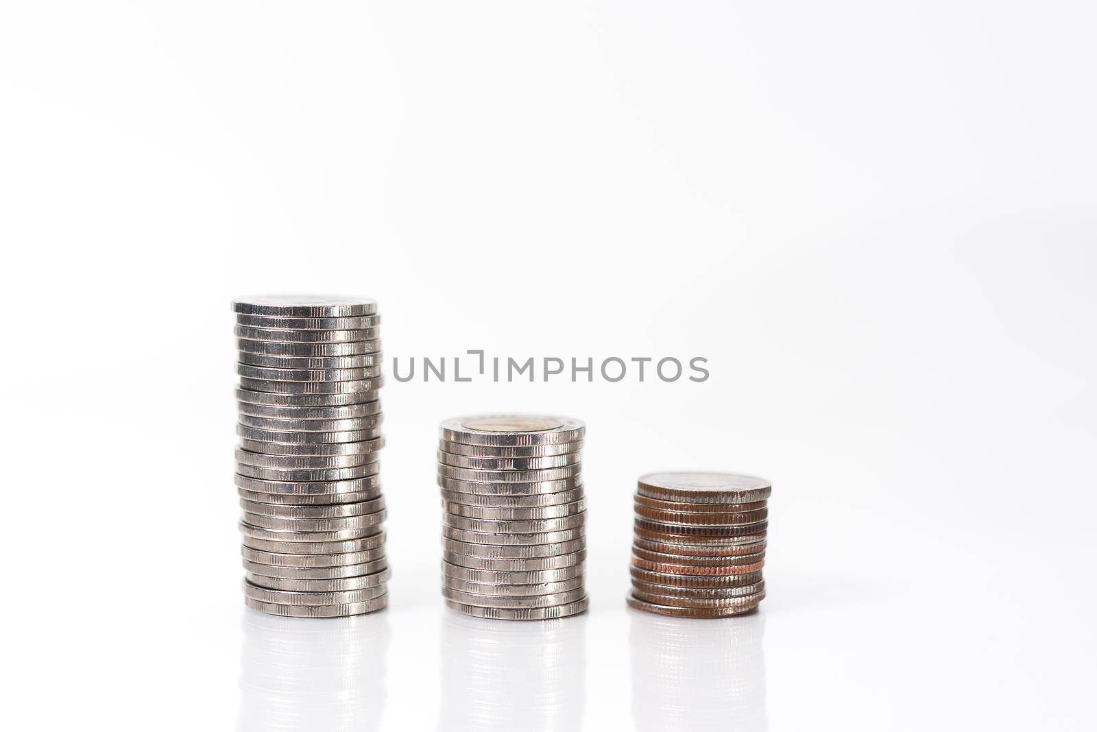 Coin stacks on a white background by Wmpix