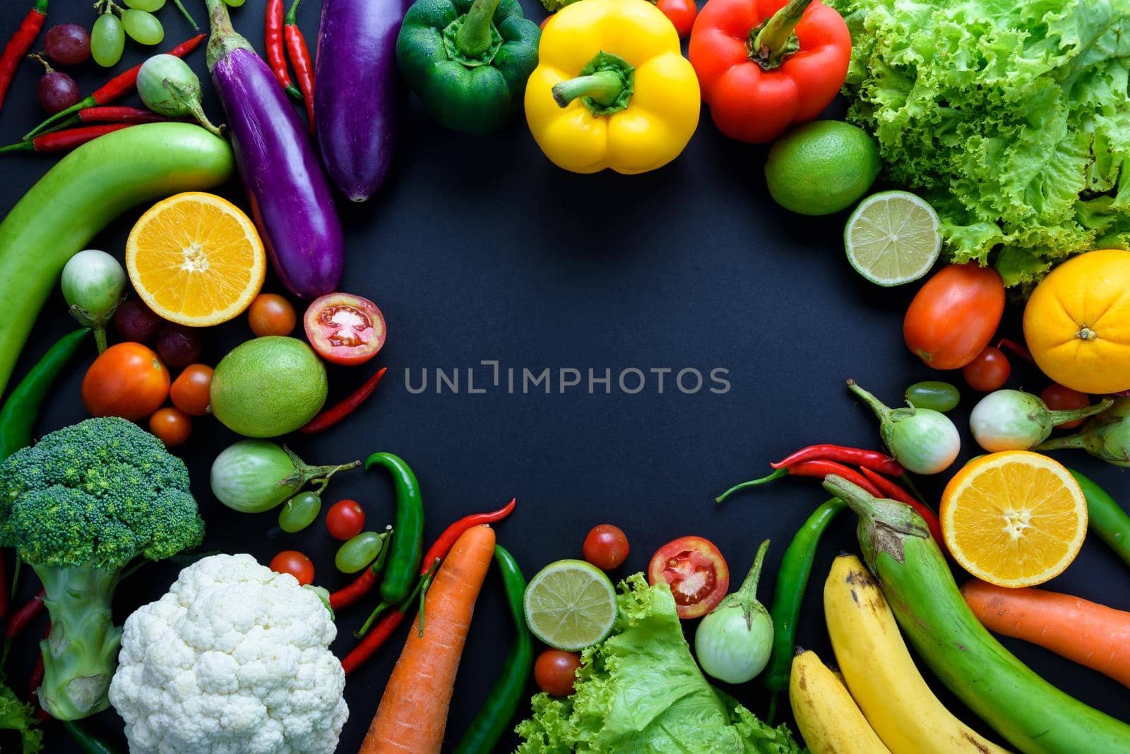 Healthy food concept of fresh organic vegetables and wooden desk background. Ingredients top view by Wmpix