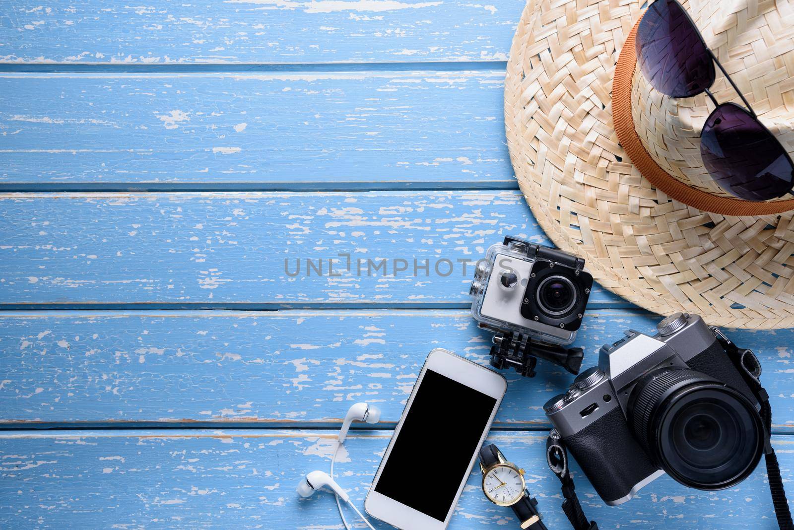 Top view of Traveler's accessories, Flat lay photography of Travel concept on blue background by Wmpix