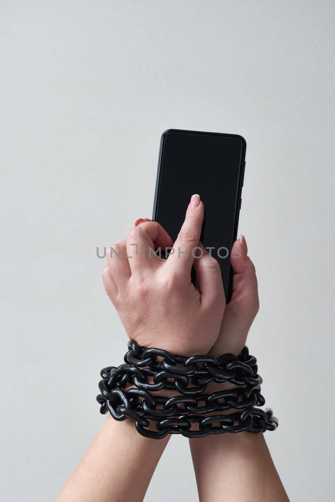 Close-Up Of Person Holding Mobile Phone And Chain