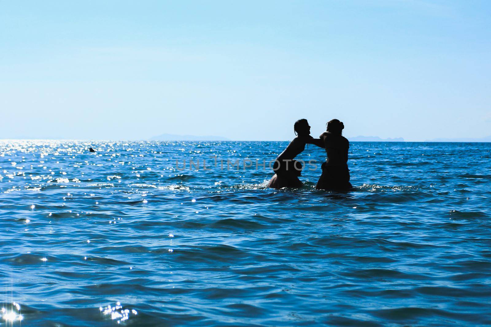 silhouette image group young people are playing on the sea by Wmpix