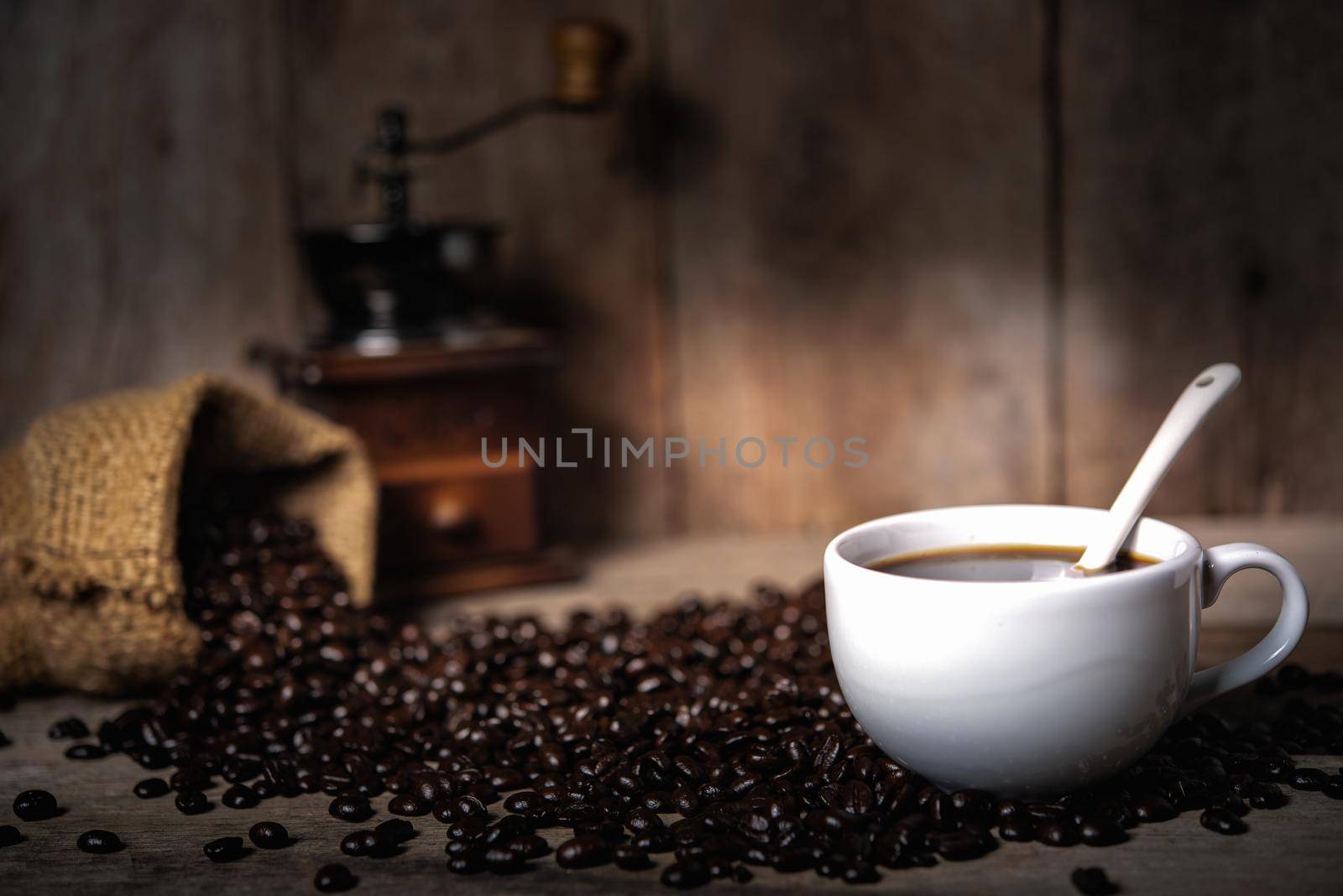 hot coffee and coffee beans on wood table by Wmpix