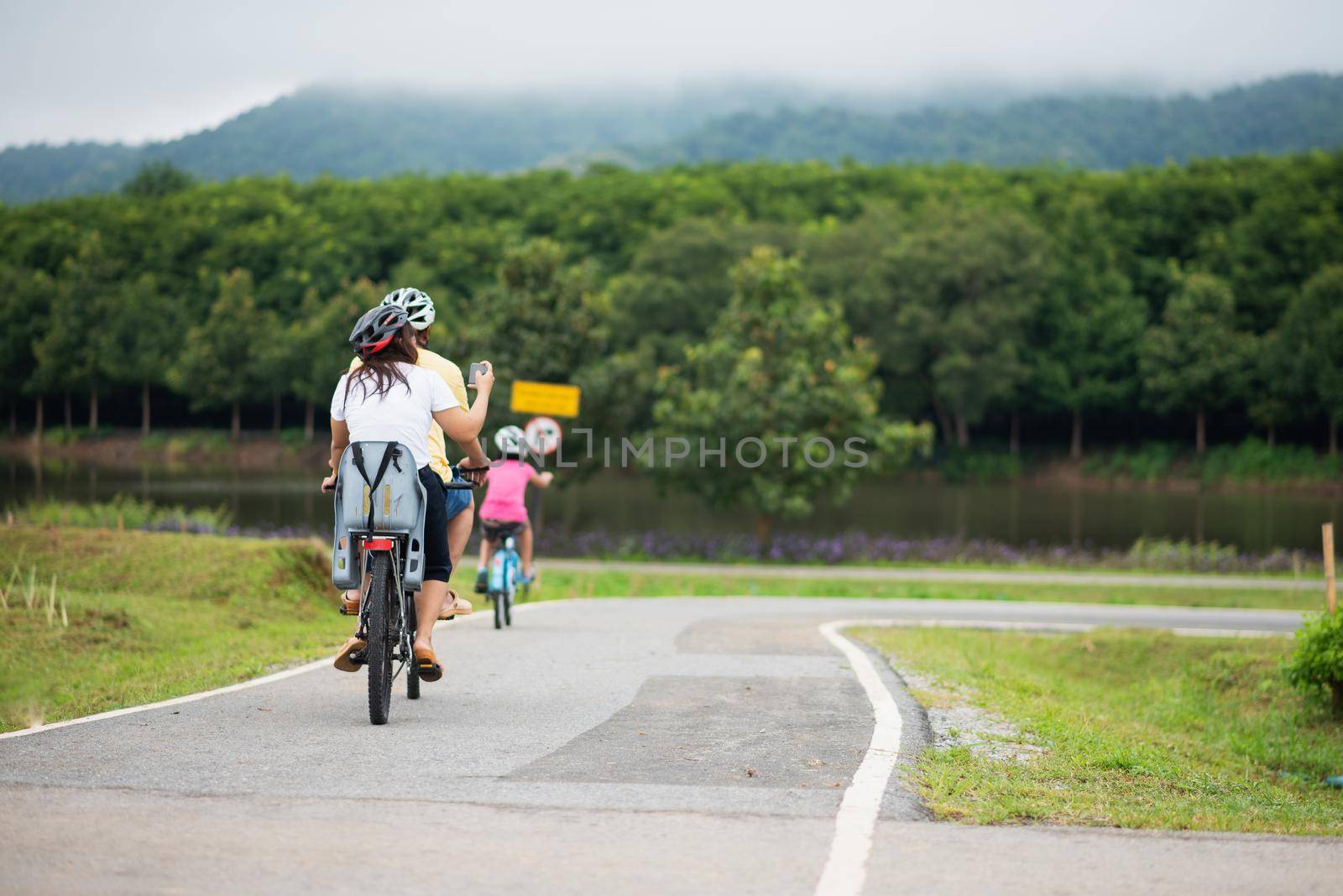 family riding bicycle in the morning