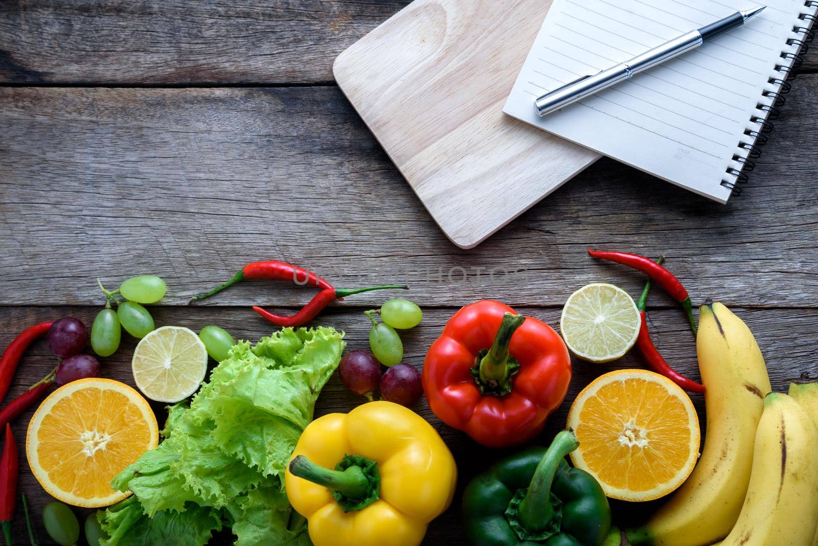 fresh vegetables and fruits for fitness dinner on wooden background top view, food concept by Wmpix