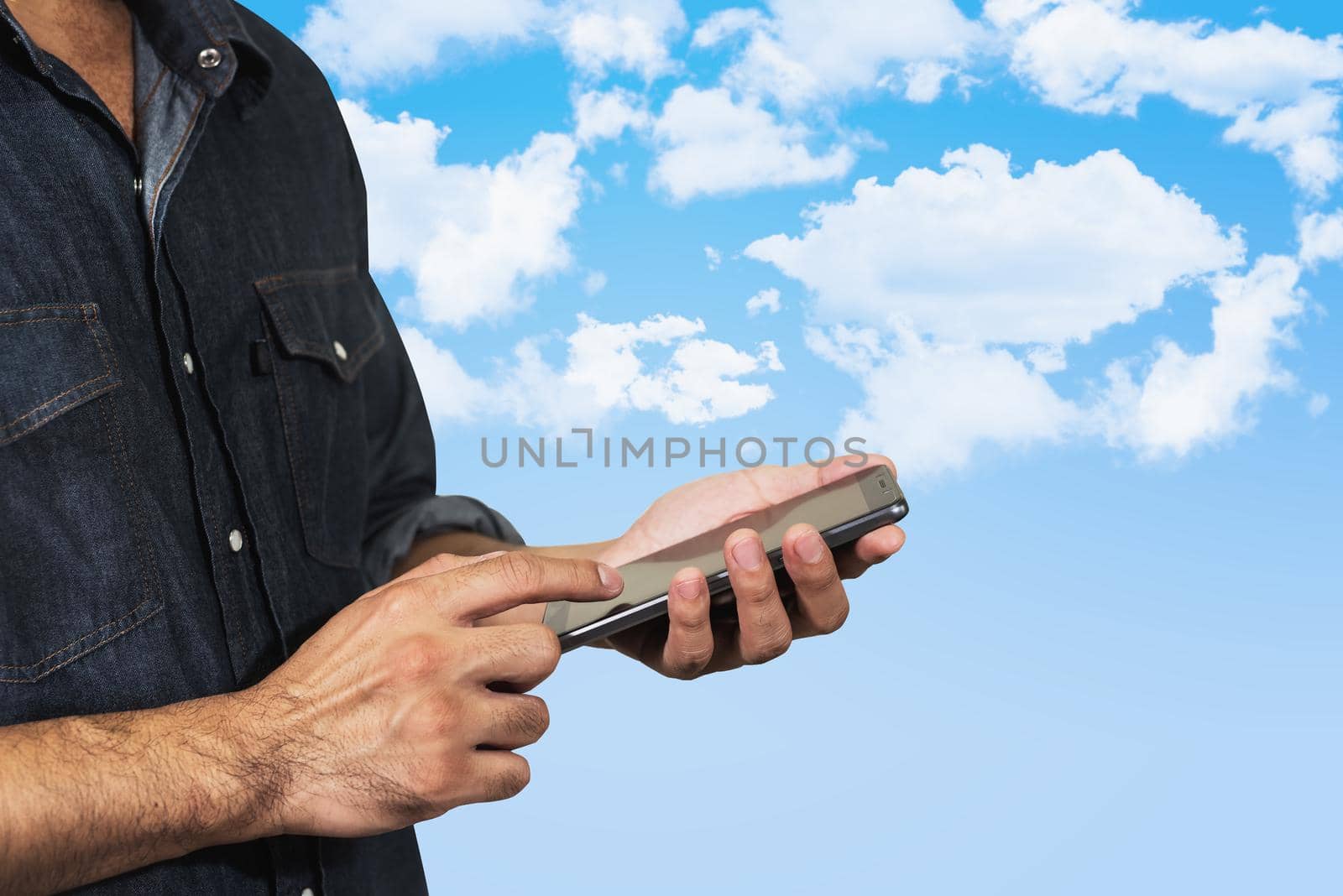 man using his mobile on sky background