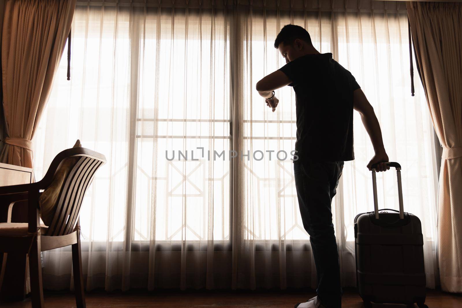 man holding luggage in the hotel