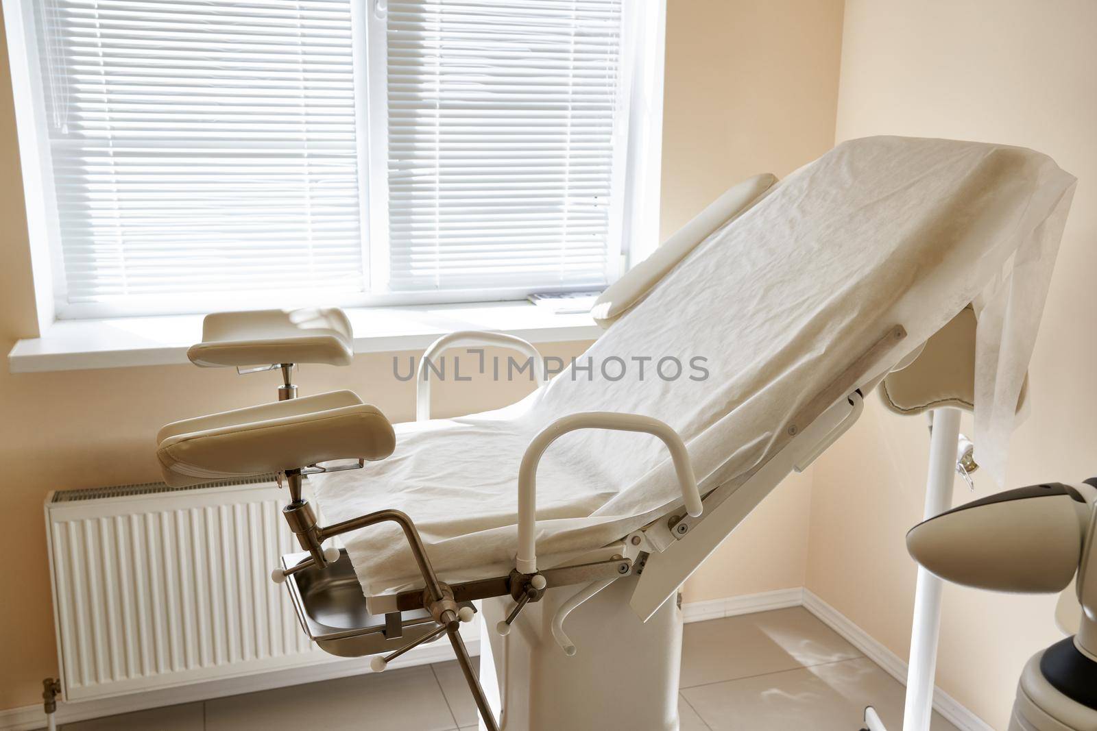 Gynecological chair in the clinic. Gynecology room, medical instruments, interior of the genicological clinic